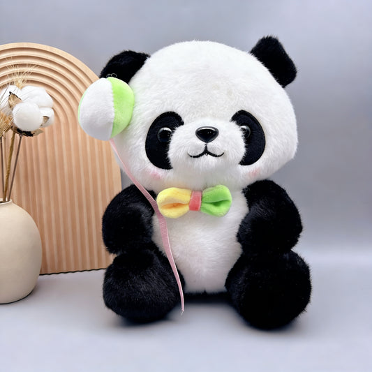 Muñeco de peluche de panda con globo y lazo